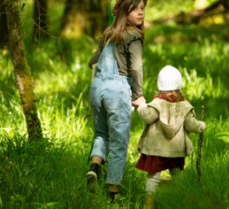 2 enfants qui marchent dans la forêt 
